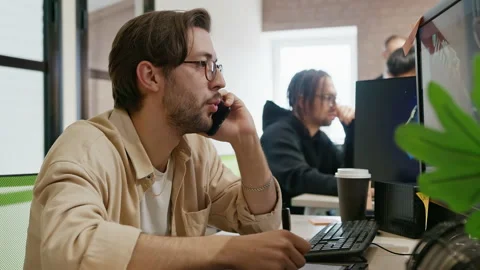 3D model artist discusses project over phone at game and app development company Stock Footage 212065845