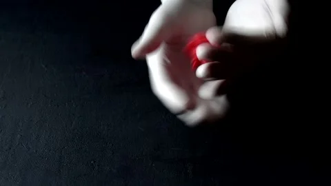 3D model of red coronavirus lies in hands in white medical disposable latex Stock Footage 152565173