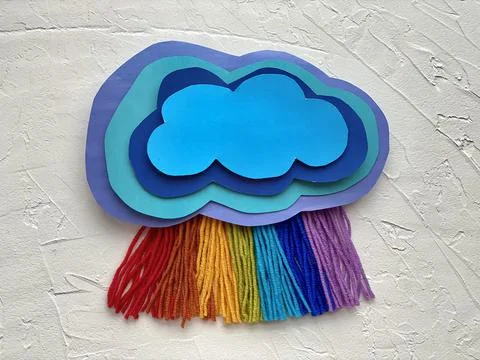 3d paper application-a cloud with a rainbow rain of yarn. Stock Photos