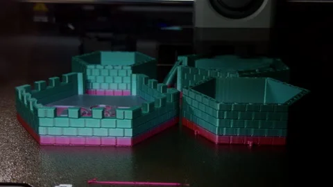 3D printed hexagonal containers on printer bed with teal and magenta light Stock Footage 345765961