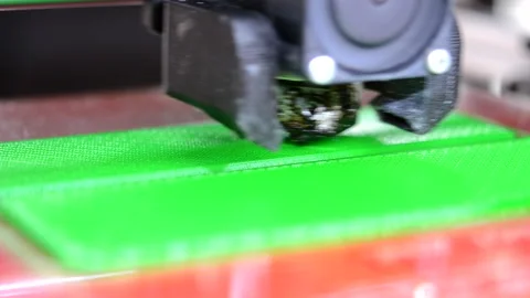 3D printer. 3d printer printing close-up. Molten plastic flowing out of extruder Stock Footage 238017531