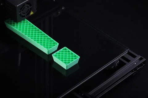 3D-printer with big exclamation mark made from green plastic Stock Photos