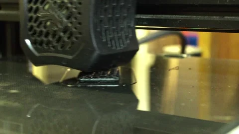 3D printer close up printing black block Stock Footage 276395938