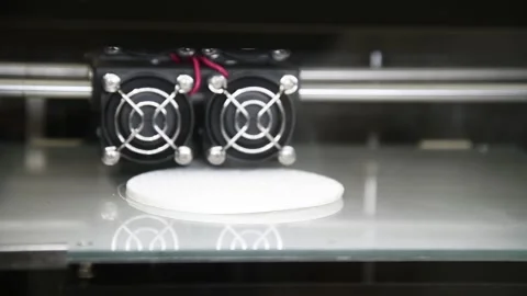3D printer close-up printing the product. The printer elements are moving. Видео 161419368
