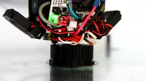 3D printer close-up printing the product. The printer elements are moving Видео 222585016