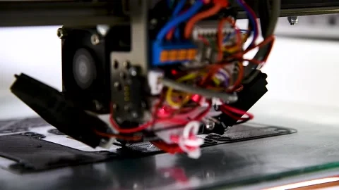 3D printer close-up printing the product. The printer elements are moving Stockbeeldmateriaal 237713666