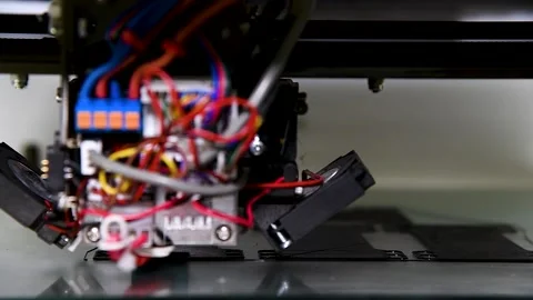 3D printer close-up printing the product. The printer elements are moving 動画素材 253667723