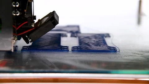 3D printer close-up printing the product. The printer elements are moving Stock Footage 254339981