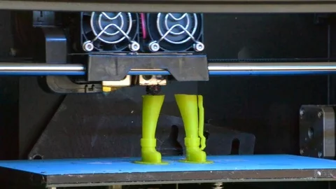 The 3D printer creates a green object Stock Footage