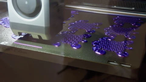 3D printer creating purple plastic parts on build platform with close up Stock-Footage 346558773