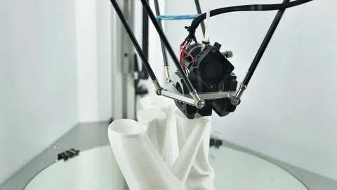 3D printer creating a white plastic prototype on a build platform Stock Footage 320520859
