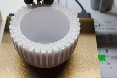 3D printer creating white ribbed flower pot close up 写真素材