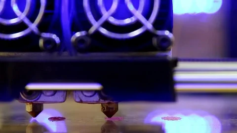 3D printer with dual extruder starts printing pink details Stock Footage 72502986