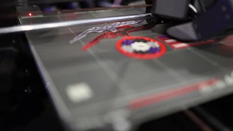 3D printer head moves precisely while creating vibrant multicolor emblem layer b Stock Footage 311130958
