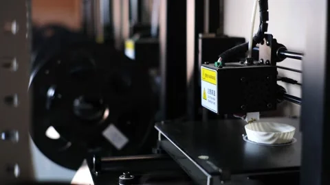 3d printer with hot end applies plastic making white cup Stock Footage 140656013
