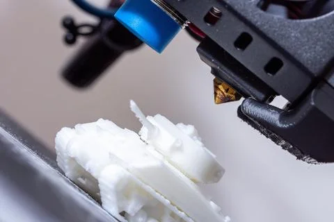 3D printer hotend. Close-up of 3D printing with FDM filament. Small plastic tank Stock Photos