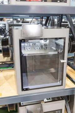 3D printer in industrial workshop, sleek rectangular machine with transpare.. Stock Photos