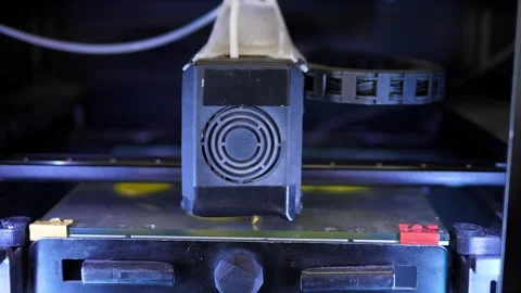 A 3D printer machine that creates a three-dimensional geometric shape. Stock Footage 288334333