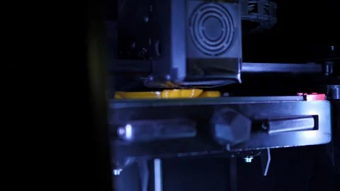 A 3D printer machine that creates a three-dimensional geometric shape. Stock Footage 311151780