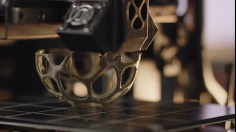 A 3d printer machine is making volume metal abstract geometric figure. The Stock Footage 258254128
