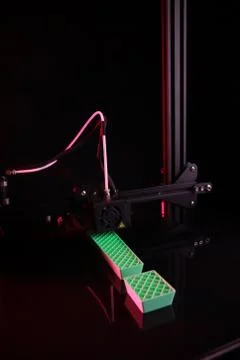 3D-printer making big exclamation mark from green plastic in pink neon light Stock Photos