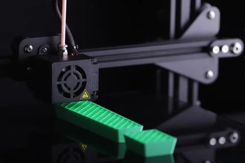 3D-printer manufacturing big exclamation mark from green plastic Stock Photos
