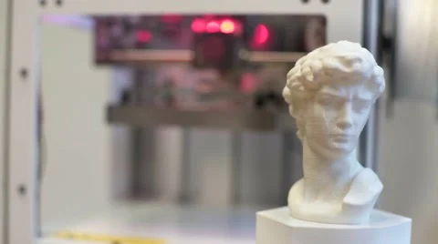 3D printer with Michelangelo's David head in the foreground. Stock Footage 67858593