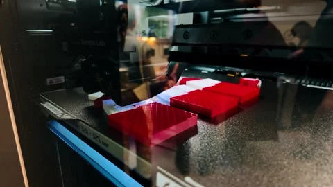 3D Printer Nozzle Printing Red and White Plastic Components in Utrecht Stock Footage 327712758