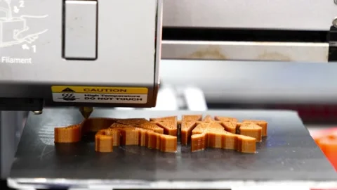 3D printer operation with orange plastic resin Stock Footage 159742350