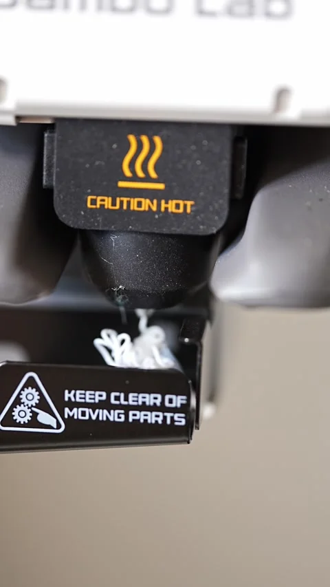 3D printer operation showing hot warning and moving parts notice Stock-Footage 344420100