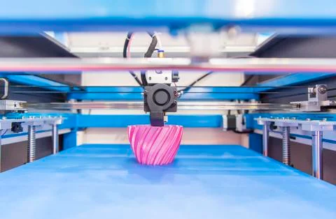 3D printer or additive manufacturing and robotic automation technology. Stock Photos