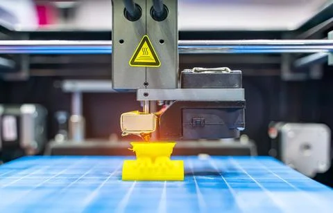 3D printer or additive manufacturing and robotic automation technology. Stock Photos