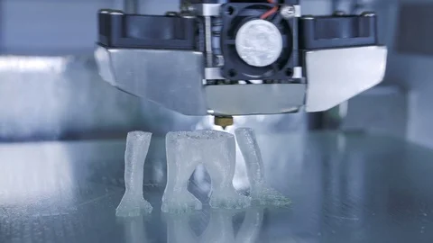 3D printer print the human like monkey using plastic filament Stock Footage 69839051
