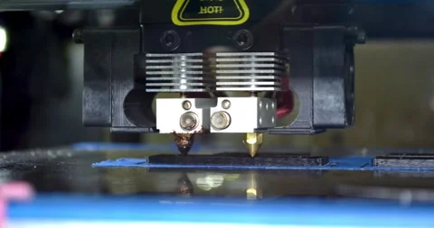 3d printer printing black flat shapes on a dark background close-up Stock Footage 149947197