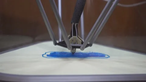 3D Printer Printing Design On Print Bed With Plastic Exiting Extruder Side V Stock Footage 165629270
