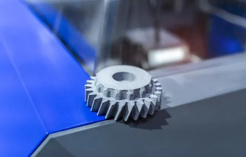 3D printer printing gear cog figure close-up. Stock Photos