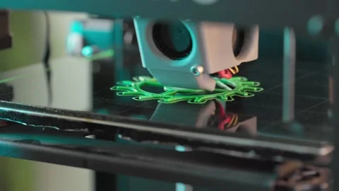 The 3d printer is printing a gear from green plastic. A layer by layer appears Stock Footage 236303097