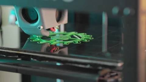 The 3d printer is printing a gear from green plastic. A layer by layer appears Stock Footage 236303244
