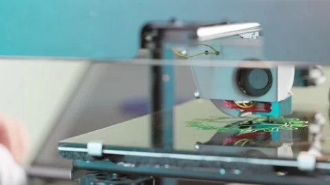 The 3d printer is printing a gear from green plastic. A layer by layer appears Stock Footage 236303831