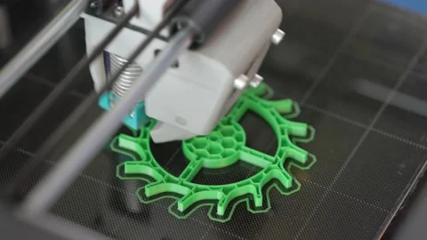 The 3d printer is printing a gear from green plastic. A layer by layer appears o Stock Footage 236303957