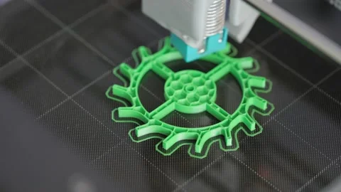 The 3d printer is printing a gear from green plastic. A layer by layer appears Stock Footage 236304215