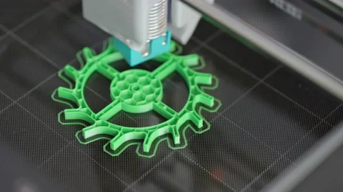 The 3d printer is printing a gear from green plastic. A layer by layer appears Stock Footage 236304382