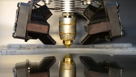 3d printer printing gray objects on mirror reflective surface close-up. Stock Footage 71168015