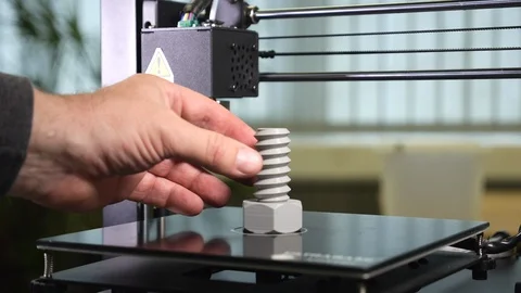 3D printer printing a gray screw, Remove the screw Stock Footage 104180332