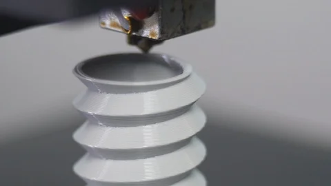 3D printer printing a gray screw, White background Stock Footage 104190616