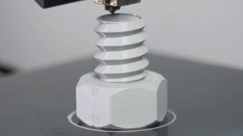 3D printer printing a gray screw, White background Stock Footage 104190737