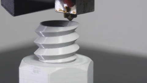 3D printer printing a gray screw, White background Stock Footage 104190813