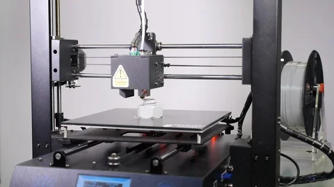 3D printer printing a gray screw, White background Stock Footage 104193158