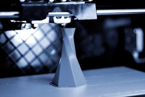 3D printer printing isolated volume triangular object blue gray color Stock Photos
