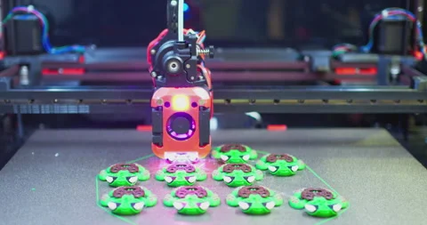 3d printer printing little green and brown turtles Stock Footage 313060425
